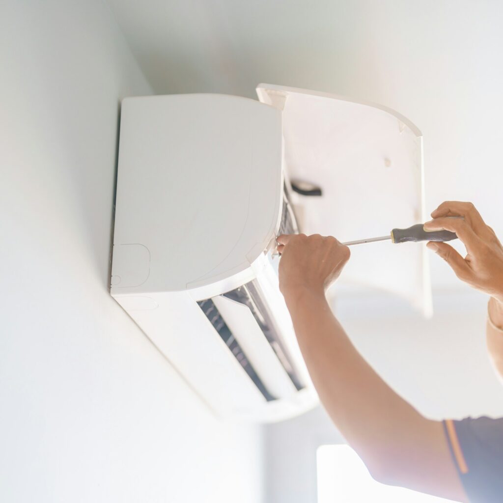 Man technician maintenance air conditioner.